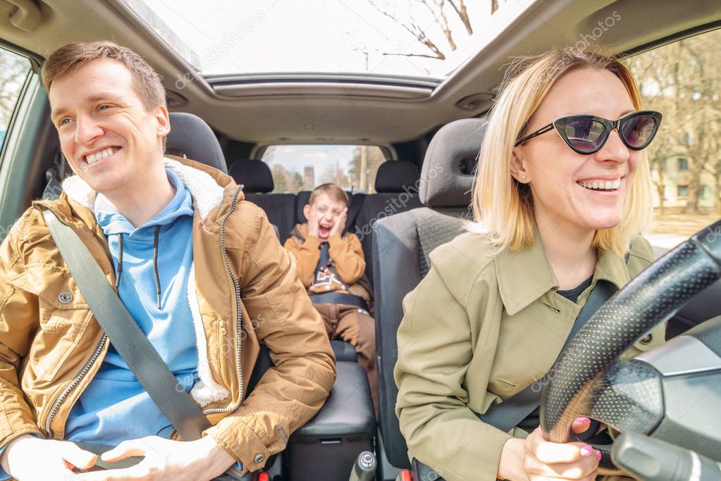 young family with little boy kid inside car. road trip concept
