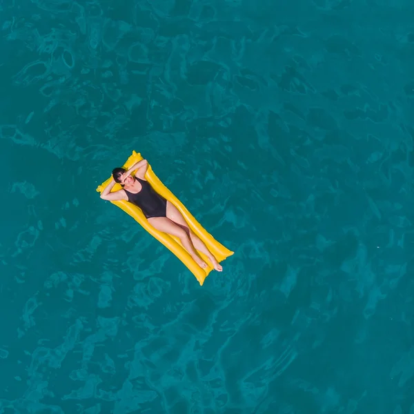 Young woman swimming in blue azure water — Stock Photo, Image