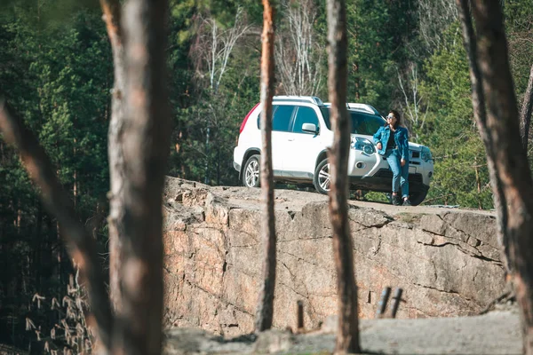 Auto suv bianco a scogliera rocciosa giovane donna vicino ad esso — Foto Stock