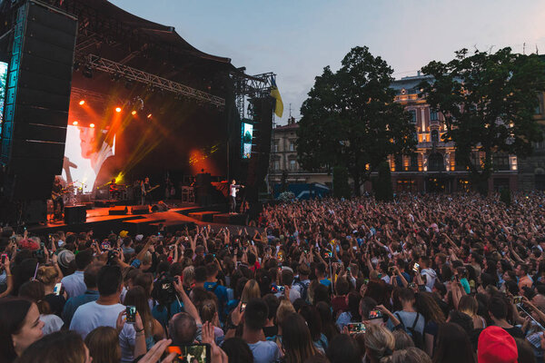 LVIV, UKRAINE - June 18, 2019: wide angel crowd before rock stage at city square