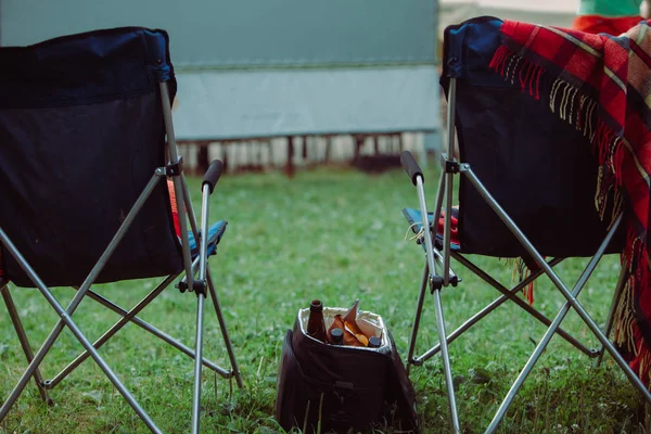 open air cinema concept folding chairs in front of big white screen