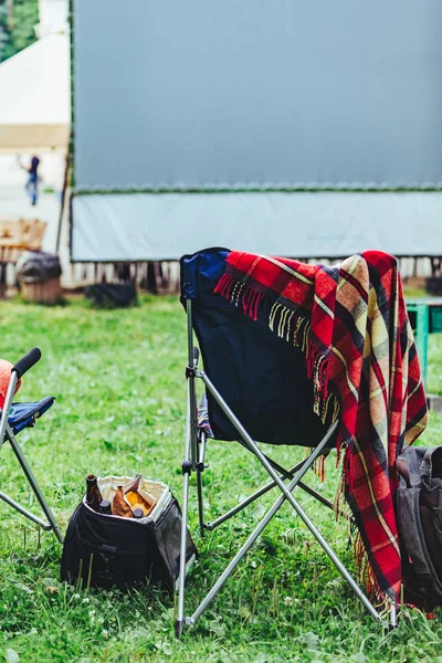 open air cinema concept folding chairs in front of big white screen