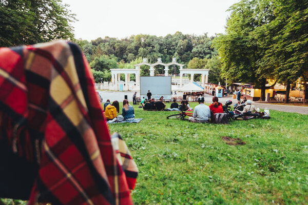 LVIV, UKRAINE - July 12, 2019: people gathered in city park to watch movie