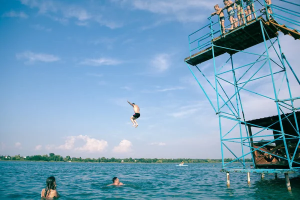 Zadorozhne, Ukrajna-július 28, 2019: emberek birtoklás móka-on nyári tó Ugrás a toronyból — Stock Fotó