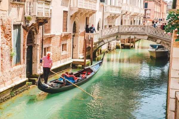 Italia, Venecia - 25 de mayo de 2019: personas en góndola haciendo un recorrido por el canal — Foto de Stock