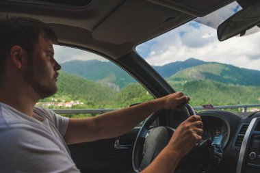 dağlara bakan araba kullanan adam