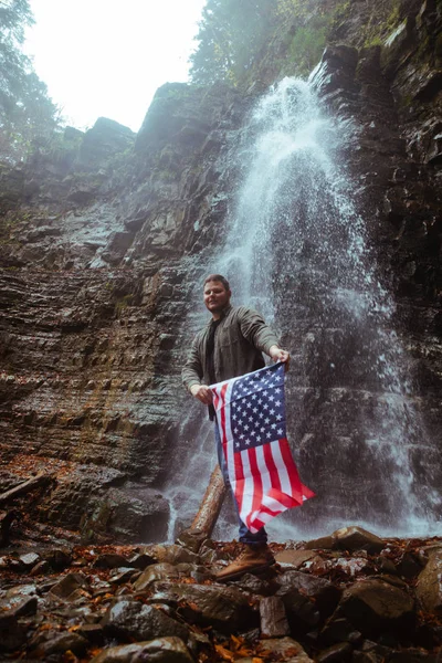 Man with usa flag waterfall on background — Stock Photo, Image