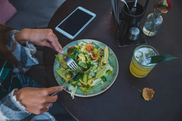 Mujer en la cafetería comiendo ensalada manos cerrar ninguna cara — Foto de Stock