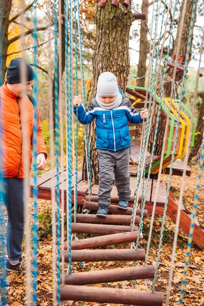 Pai com criança criança filho brincando no playground outono temporada — Fotografia de Stock