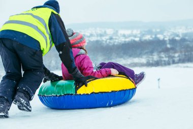winter fun activities. ride down by hill on snow tubing