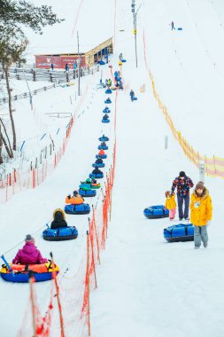 LVIV, UKRAINE - January 7, 2019: line for snow tubing. pull people up to hill.