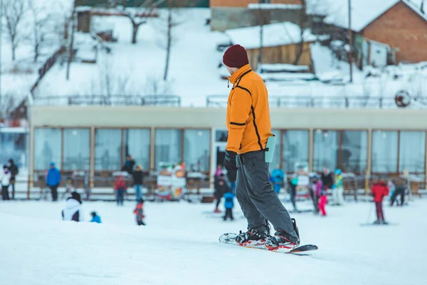 Молодой человек катается на сноуборде на зимней горке — стоковое фото