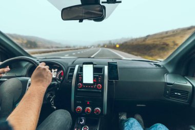 car travel concept autumn highway phone with white screen on dashboard