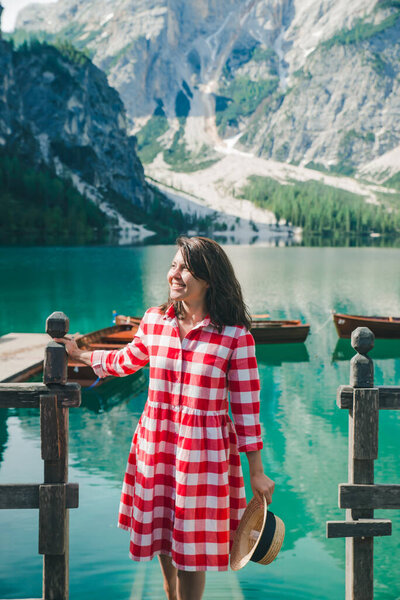 portrait of smiling gorgeous woman at boat station. mountain lake on background