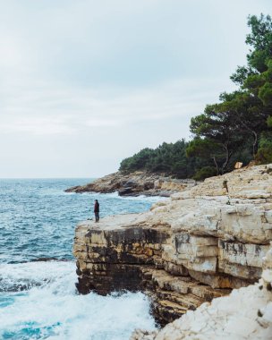 Adam kıyıda durup rüzgarlı havayı seyrediyor. Yaşam tarzı konsepti. yaz seyahati