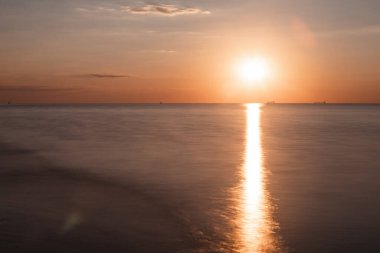 Deniz üzerinde gün batımı manzarası. Uzun pozlama. Boşluğu kopyala