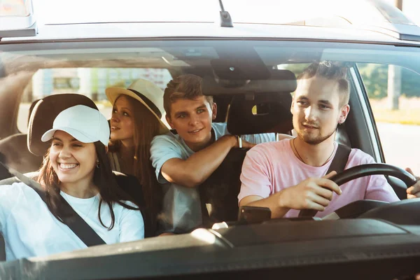 group of friends in car. road trip concept. summer vacation. friendship