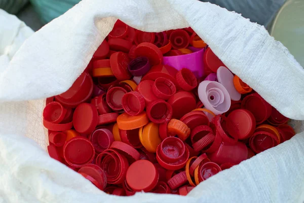 Colorful red plastic bottle caps background in cellophone packag
