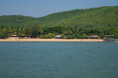 Sea and green mountain landscape of Om beach in Gokarna, India clipart