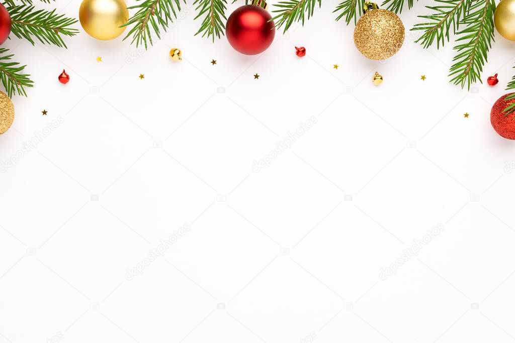 Christmas frame with fir tree branches and festive decoration at white background. Christmas flat lay with space for text.