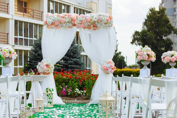 Arch for the wedding ceremony, decorated in delicate colors