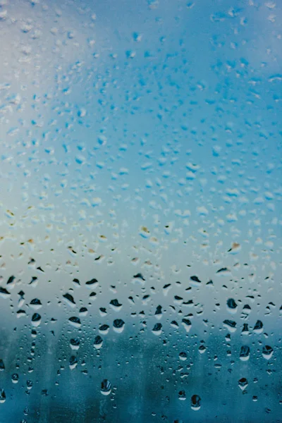 Water drops from home condensation on a window. Misted glass background. Strong humidity in wintertime