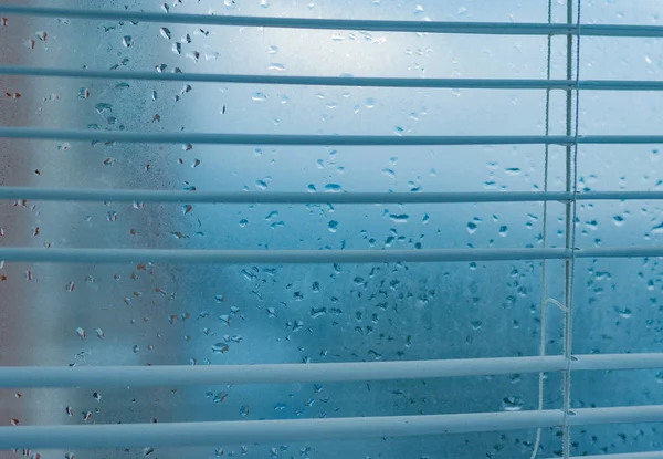 Water drops from home condensation on a window. Misted glass background. Strong humidity in wintertime