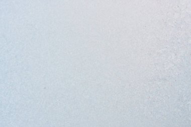 Winter background with gleaming ice. Frozen water texture. Copy space