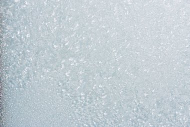 Winter background with gleaming ice. Frozen water texture. Copy space