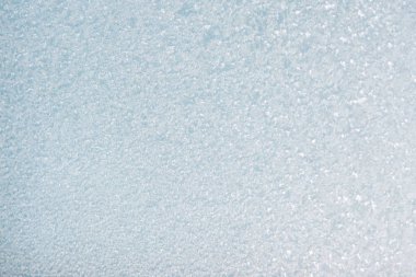 Winter background with gleaming ice. Frozen water texture. Copy space