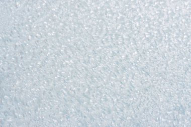 Winter background with gleaming ice. Frozen water texture. Copy space
