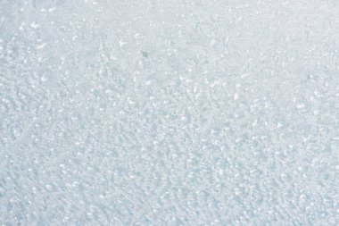 Winter background with gleaming ice. Frozen water texture. Copy space