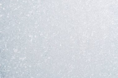 Winter background with gleaming ice. Frozen water texture. Copy space