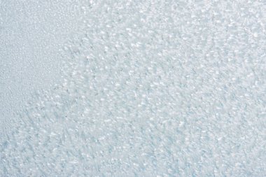 Winter background with gleaming ice. Frozen water texture. Copy space