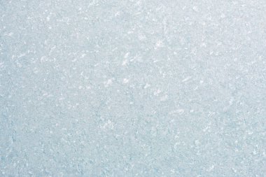 Winter background with gleaming ice. Frozen water texture. Copy space