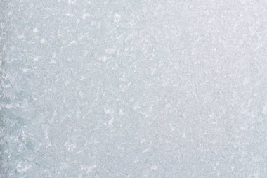 Winter background with gleaming ice. Frozen water texture. Copy space