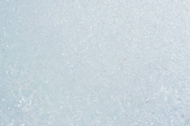 Winter background with gleaming ice. Frozen water texture. Copy space