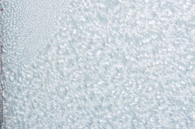 Ice background, frozen water with glass. Winter texture. Copy space