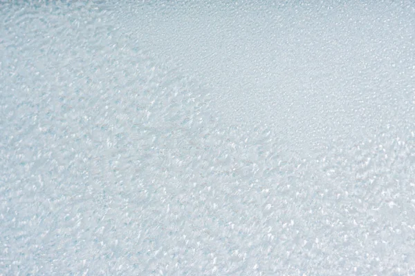 Winter background with gleaming ice. Frozen water texture. Copy space