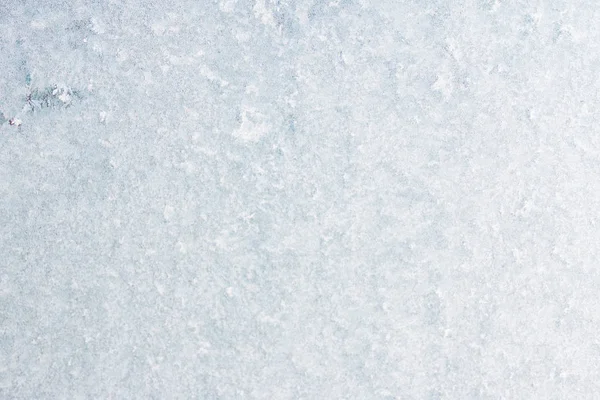 Winter background with gleaming ice. Frozen water texture. Copy space