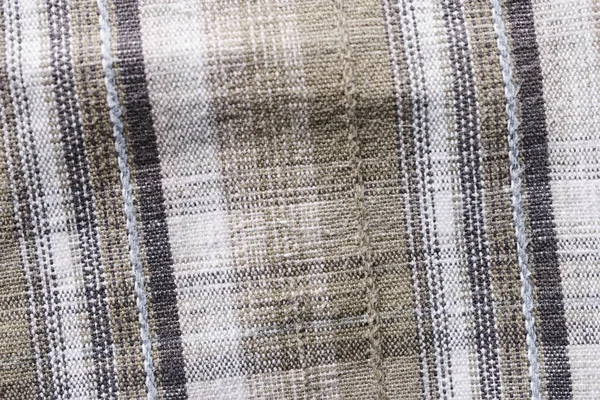 Close up part of a shirt from hemp fabric. Casual man\'s shirt with pattern. Wrinkled texture from hemp and cotton background