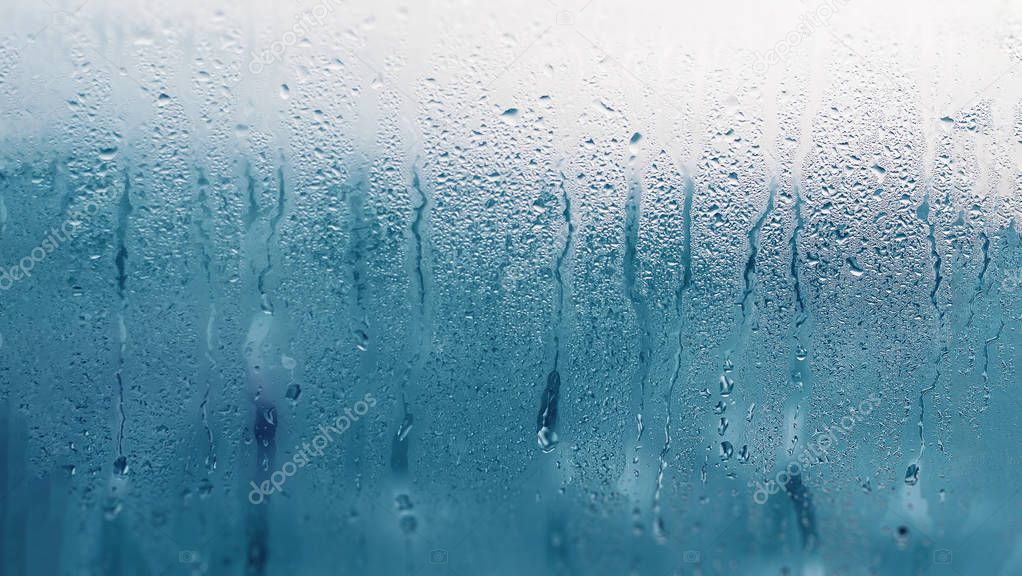 Dripping Condensation on the clear glass window. Water drops. Ab