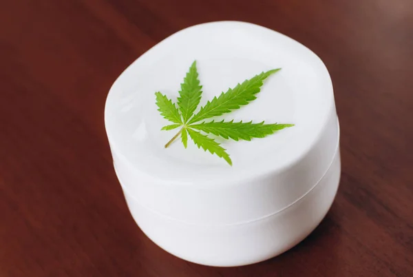 Detail of cannabis hemp cream with marijuana leaf - cannabis top