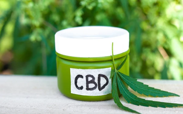 Hemp CBD cream, medical marijuana and cream in jar, legal light
