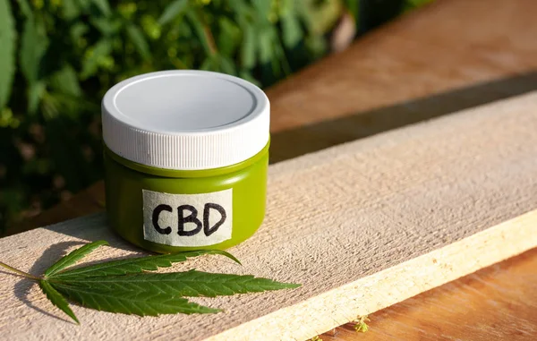 Hemp CBD cream, medical marijuana and cream in jar, legal light