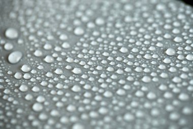 Çok fazla su damlası var. Soyut arkaplan dokusu. Sağlam bir zemin üzerinde şelaleler, temiz bir yüzey üzerinde kabarcıklar topluyor. Yağmur damlaları, bir dizi doğal fotoğraf.