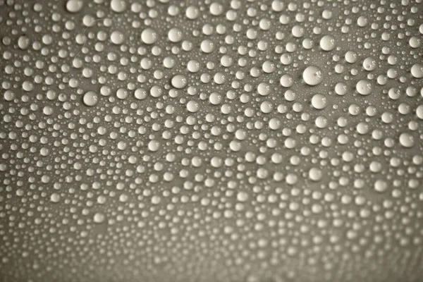 Water drops on light background, top view, close-up, macro. Great background with natural water drops and natural light