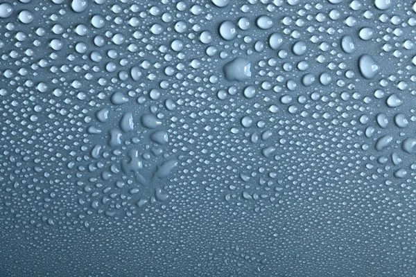 Water drops on light background, top view, close-up, macro. Great background with natural water drops and natural light