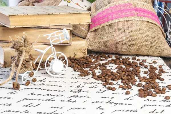 Coffee collection. Roasted black coffee beans on table, vintage turk for coffee, coffee beans on table with linen table cloth