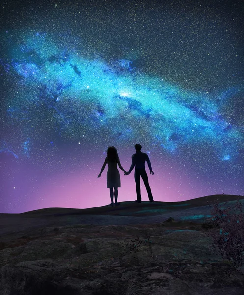 stock image Concept of a young couple silhouetted, holding hands, looking at the Milky Way, galaxy, stars, 3d render illustration